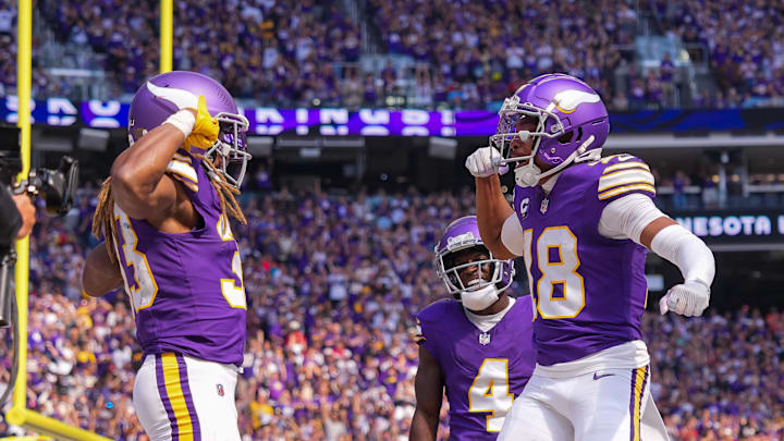Sep 22, 2024; Minneapolis, Minnesota, USA; Minnesota Vikings running back Aaron Jones (33) celebrates his touchdown with wide receiver Justin Jefferson (18) against the Houston Texans in the first quarter at U.S. Bank Stadium. Mandatory Credit: Brad Rempel-Imagn Images