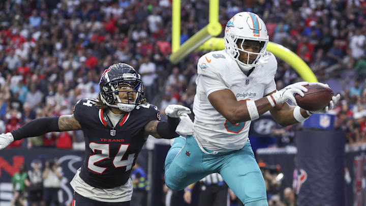 Miami Dolphins tight end Jonnu Smith (9) makes a reception for a touchdown as Houston Texans cornerback Derek Stingley Jr. (24) defends during the third quarter at NRG Stadium. 