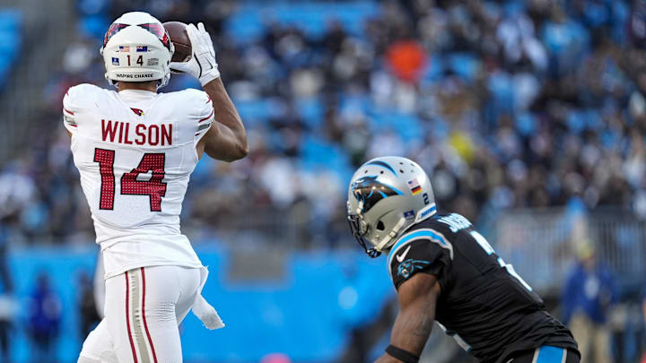 Dec 22, 2024; Charlotte, North Carolina, USA; Arizona Cardinals wide receiver Michael Wilson (14) jumps for a reception defended by Carolina Panthers cornerback Dane Jackson (23) during the second half at Bank of America Stadium. Mandatory Credit: Jim Dedmon-Imagn Images