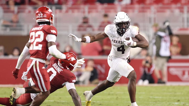 Oct 18, 2025; Fayetteville, Arkansas, USA; Texas A&M Aggies running back Rueben Owens II (4) rushes during the fourth quarter against the Arkansas Razorbacks at Donald W. Reynolds Razorback Stadium. Mandatory Credit: Nelson Chenault-Imagn Images