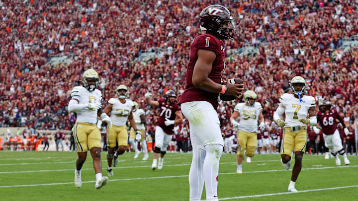 Oct 26, 2024; Blacksburg, Virginia, USA; Virginia Tech Hokies quarterback Kyron Drones (1) catches a touchdown pass during the first quarter against the Georgia Tech Yellow Jackets at Lane Stadium. Mandatory Credit: Peter Casey-Imagn Images Oct 26, 2024; Blacksburg, Virginia, USA; Virginia Tech Hokies quarterback Kyron Drones (1) catches a touchdown pass during the first quarter against the Georgia Tech Yellow Jackets at Lane Stadium. Mandatory Credit: Peter Casey-Imagn Images