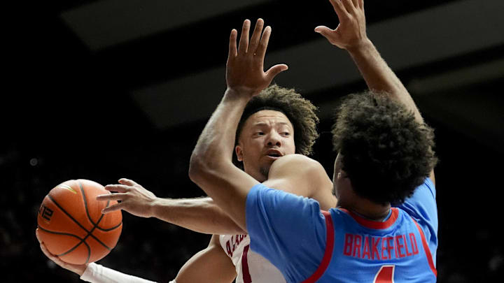 Jan 14, 2025; Tuscaloosa, AL, USA;  Alabama guard Mark Sears (1) looks for a passing lane as he is defended by Ole Miss forward Jaemyn Brakefield (4) at Coleman Coliseum. Mandatory Credit: Gary Cosby Jr.-USA TODAY Network via Imagn Images