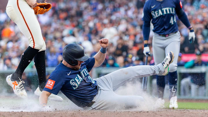 Seattle Mariners outfielder Luke Raley (20) comes home on a passed ball to score during the eleventh inning against the San Francisco Giants at Oracle Park on April 4.