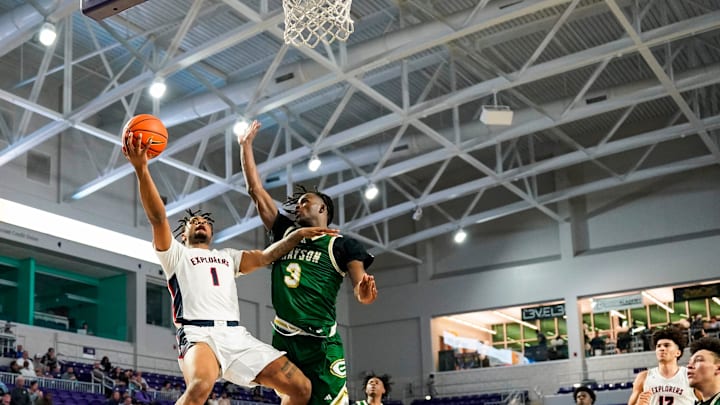Columbus Explorers guard Cello Jackson (1) makes a lay up on a breakaway as Grayson Rams guard Caleb Holt (3) tries to defend during the third quarter of a City of Palms Classic quarterfinal game at Suncoast Credit Union Arena in Fort Myers, Fla., on Friday, Dec. 20, 2024.