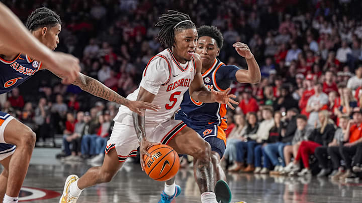 Jan 3, 2026; Athens, Georgia, USA; Georgia Bulldogs guard Jeremiah Wilkinson (5) dribbles past Auburn Tigers guard Tahaad Pettiford (0) during the first half at Stegeman Coliseum. Mandatory Credit: Dale Zanine-Imagn Images