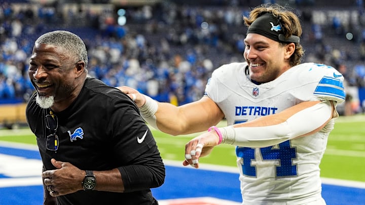 Detroit Lions defensive coordinator Aaron Glenn and linebacker Malcolm Rodriguez (44) celebrate 24-6 win over Indianapolis Colts as they exit the field at Lucas Oil Stadium in Indianapolis, Ind. on Sunday, Nov. 24, 2024.