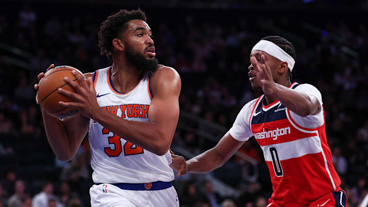 Oct 9, 2024; New York, New York, USA; New York Knicks center Karl-Anthony Towns (32) secures a rebound in front of Washington Wizards guard Bilal Coulibaly (0) during the first half at Madison Square Garden. Mandatory Credit: Vincent Carchietta-Imagn Images