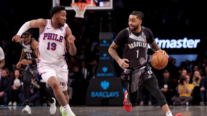 Feb 12, 2025; Brooklyn, New York, USA; Brooklyn Nets guard D'Angelo Russell (1) brings the ball up court against Philadelphia 76ers forward Justin Edwards (19) during the first quarter at Barclays Center. Mandatory Credit: Brad Penner-Imagn Images