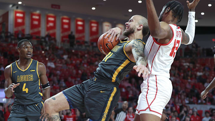 Dec 13, 2022; Houston, Texas, USA; North Carolina A&T Aggies forward Duncan Powell (31) and Houston Cougars forward J'Wan Roberts (13) battle for a loose ball during the first half at Fertitta Center. Mandatory Credit: Troy Taormina-USA TODAY Sports
