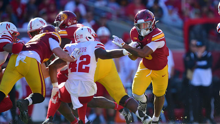 Nov 16, 2024; Los Angeles, California, USA; Southern California Trojans running back Quinten Joyner (0) runs the ball against Nebraska Cornhuskers linebacker Mikai Gbayor (42) during the first half at the Los Angeles Memorial Coliseum. Mandatory Credit: Gary A. Vasquez-Imagn Images