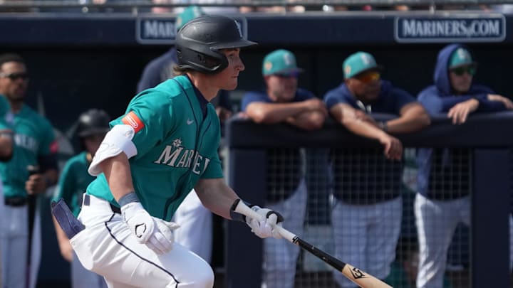 Feb 26, 2026; Peoria, Arizona, USA; Seattle Mariners shortstop Colt Emerson (85) hits a single against the Cleveland Guardians in the second inning at Peoria Sports Complex. Mandatory Credit: Rick Scuteri-Imagn Images