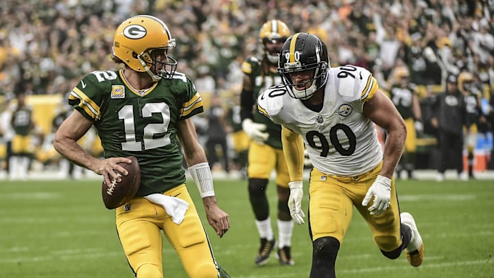 Oct 3, 2021; Green Bay, Wisconsin, USA; Green Bay Packers quarterback Aaron Rodgers (12) beats Pittsburgh Steelers linebacker T.J. Watt (90) to the end zone for a touchdown in the first quarter at Lambeau Field.