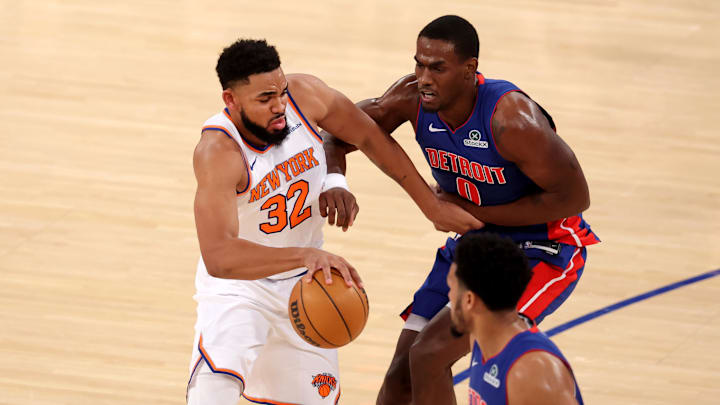 Jan 13, 2025; New York, New York, USA; New York Knicks center Karl-Anthony Towns (32) drives to the basket against Detroit Pistons center Jalen Duren (0) and forward Tobias Harris (12) during the first quarter at Madison Square Garden. Mandatory Credit: Brad Penner-Imagn Images