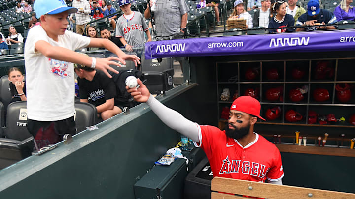 Sep 20, 2025; Denver, Colorado, USA; Los Angeles Angels outfielder Jo Adell (7) signs an autograph for a fan before the game against the Colorado Rockies at Coors Field. Mandatory Credit: Christopher Hanewinckel-Imagn Images