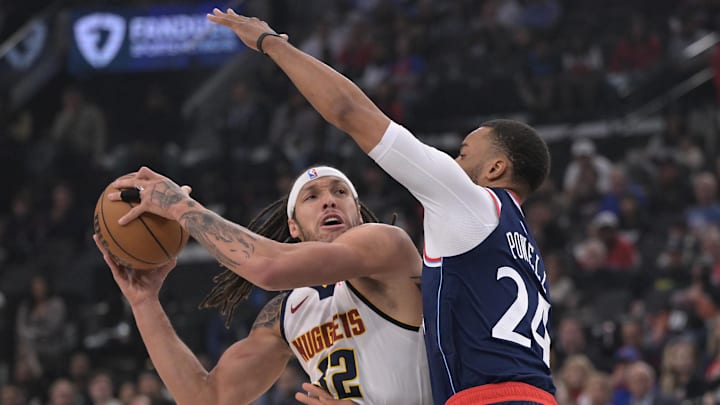 Apr 26, 2025; Inglewood, California, USA; Denver Nuggets forward Aaron Gordon (32) is defended by Los Angeles Clippers guard Norman Powell (24) as he drives to the basket in the first half of game four of round one of the 2024 NBA Playoffs at Intuit Dome. Mandatory Credit: Jayne Kamin-Oncea-Imagn Images