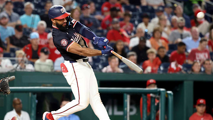 Jul 21, 2025; Washington, District of Columbia, USA; Washington Nationals third baseman Amed Rosario (13) hits an RBI double during the sixth inning against the Cincinnati Reds at Nationals Park. Mandatory Credit: Daniel Kucin Jr.-Imagn Images