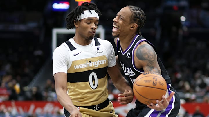 Feb 1, 2026; Washington, District of Columbia, USA; Sacramento Kings guard DeMar DeRozan (10) tries to slip past Washington Wizards guard Bilal Coulibaly (0) during the second half at Capital One Arena. Mandatory Credit: Daniel Kucin Jr.-Imagn Images
