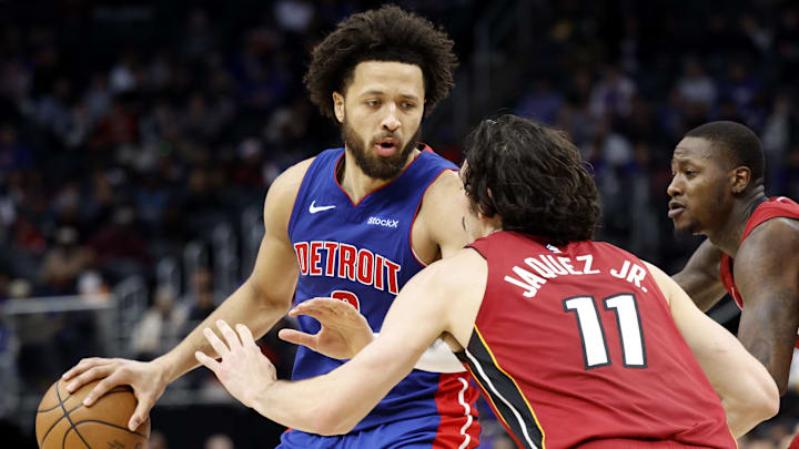 Dec 16, 2024; Detroit, Michigan, USA; Detroit Pistons guard Cade Cunningham (2) controls the ball as Miami Heat guard Jaime Jaquez Jr. (11) defends in the second half at Little Caesars Arena. Mandatory Credit: Rick Osentoski-Imagn Images