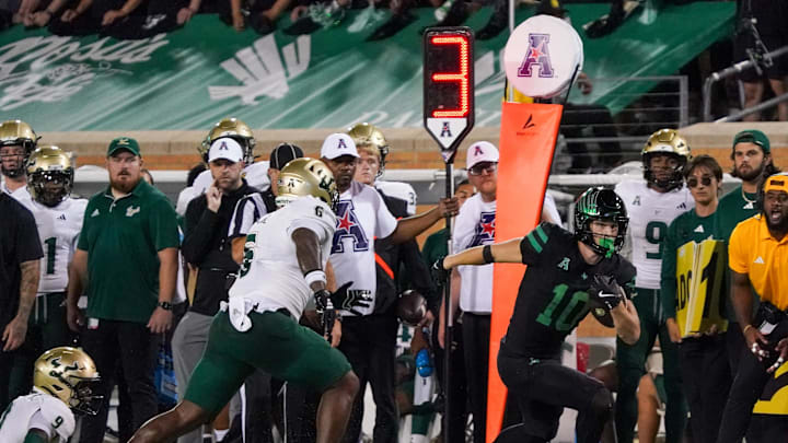 Oct 10, 2025; Denton, Texas, USA; North Texas Mean Green wide receiver Wyatt Young (10) runs after the catch as South Florida Bulls linebacker Rodney Hill (6) defends during the second half of a game at DATCU Stadium. Mandatory Credit: Raymond Carlin III-Imagn Images