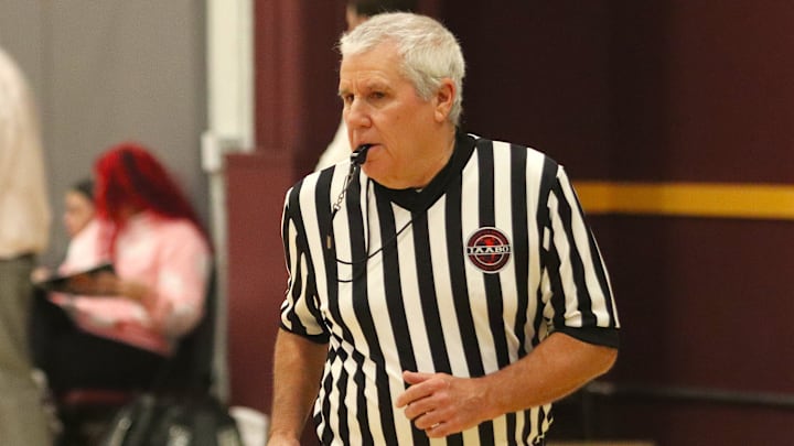 Former Taunton Daily Gazette and Herald News sports editor Mike Silva referees an MIAA-MCSAO crossover girls basketball game between Bristol Aggie and Argosy Collegiate Charter at Bristol County Agricultural High School on Dec. 13, 2024.