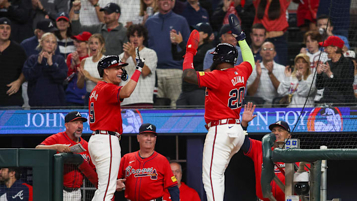 Sep 27, 2024; Atlanta, Georgia, USA; Atlanta Braves designated hitter Marcell Ozuna (20) celebrates after scoring with third baseman Gio Urshela (9) against the Kansas City Royals in the eighth inning at Truist Park. Mandatory Credit: Brett Davis-Imagn Images
