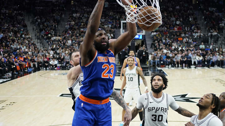 Mar 19, 2025; San Antonio, Texas, USA; New York Knicks center Mitchell Robinson (23) dunks over San Antonio Spurs guard Stephon Castle (5) and forward Julian Champagnie (30) during the second half at Frost Bank Center. Mandatory Credit: Scott Wachter-Imagn Images