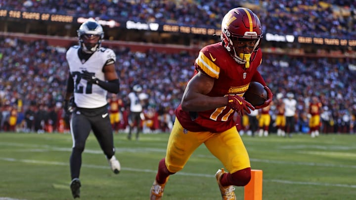 Dec 22, 2024; Landover, Maryland, USA; Washington Commanders wide receiver Terry McLaurin (17) catches a touchdown pass against Philadelphia Eagles cornerback Quinyon Mitchell (27) during the second quarter at Northwest Stadium. Dec 22, 2024; Landover, Maryland, USA; Washington Commanders wide receiver Terry McLaurin (17) catches a touchdown pass against Philadelphia Eagles cornerback Quinyon Mitchell (27) during the second quarter at Northwest Stadium.