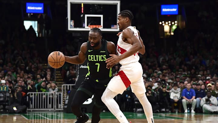 Dec 31, 2024; Boston, Massachusetts, USA;  Toronto Raptors guard Ochai Agbaji (30) defends Boston Celtics guard Jaylen Brown (7) during the first half at TD Garden. Mandatory Credit: Bob DeChiara-Imagn Images