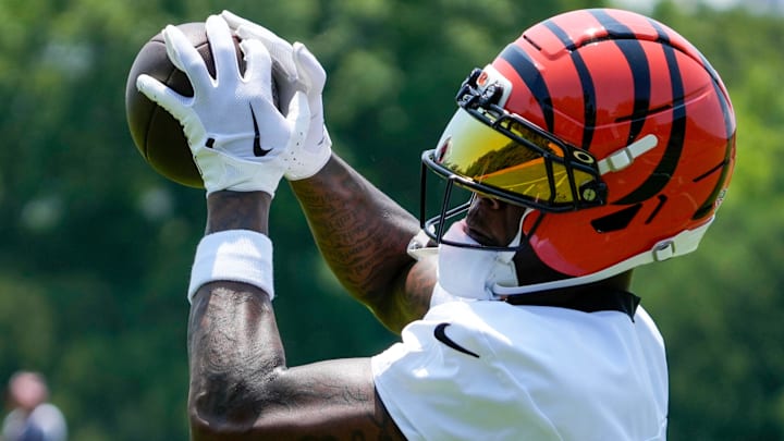 Cincinnati Bengals wide receiver Tee Higgins (5) catches a pass during a session of organized team activities on the Bengals practice field at Paycor Stadium in downtown Cincinnati on Tuesday, June 3, 2025. Cincinnati Bengals wide receiver Tee Higgins (5) catches a pass during a session of organized team activities on the Bengals practice field at Paycor Stadium in downtown Cincinnati on Tuesday, June 3, 2025.