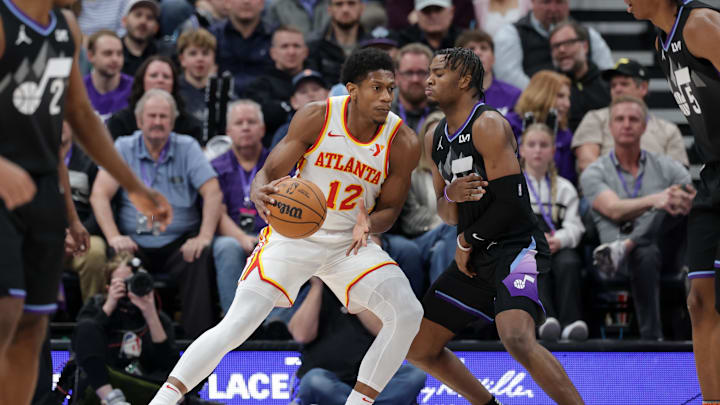 Jan 7, 2025; Salt Lake City, Utah, USA; Atlanta Hawks forward De'Andre Hunter (12) protects the ball from Utah Jazz guard Isaiah Collier (13) during the second half at Delta Center. Mandatory Credit: Chris Nicoll-Imagn Images Jan 7, 2025; Salt Lake City, Utah, USA; Atlanta Hawks forward De'Andre Hunter (12) protects the ball from Utah Jazz guard Isaiah Collier (13) during the second half at Delta Center. Mandatory Credit: Chris Nicoll-Imagn Images