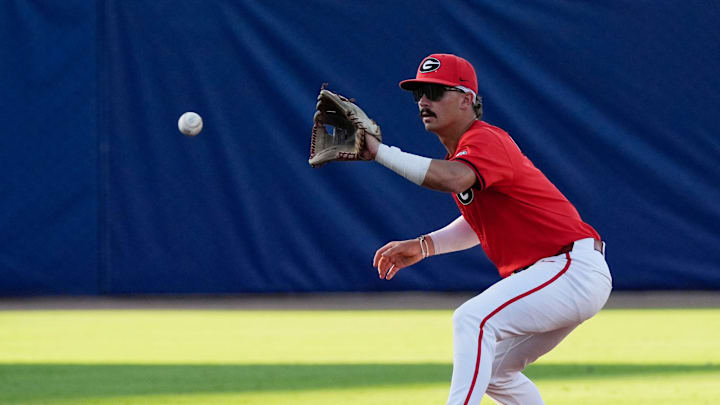 May 21, 2025; Hoover, AL, USA; Georgia shortstop Kolby Branch (9) fields a ball before throwing to first for an out during the game with Oklahoma in the second round of the SEC Baseball Tournament at the Hoover Met.