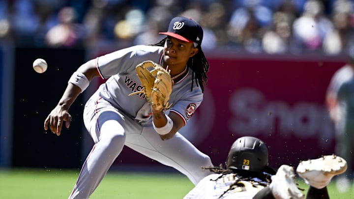 Jun 25, 2025; San Diego, California, USA; San Diego Padres right fielder Fernando Tatis Jr. (23) steals second base ahead of the throw to Washington Nationals shortstop CJ Abrams (5) during the eighth inning at Petco Park. 