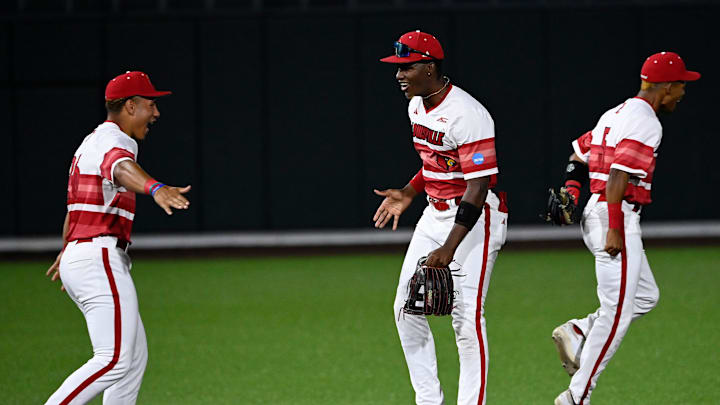 Louisville’s Nate Earley (26), Lucas Moore (53), and Kamau Neighbors (5) celebrate their win against Vanderbilt in the Nashville Regional NCAA Baseball Tournament game at Hawkins Field Saturday, May 31, 2025, in Nashville, Tenn.