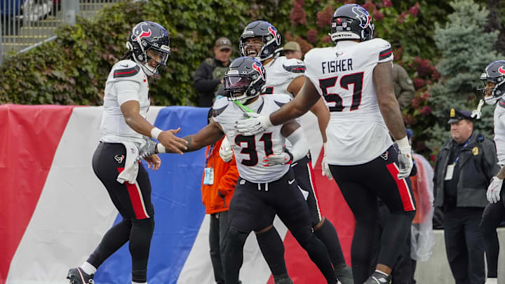Oct 13, 2024; Foxborough, Massachusetts, USA; Houston Texans quarterback C.J. Stroud (7) and Houston Texans offensive tackle Blake Fisher (57) congratulate Houston Texans running back Dameon Pierce (31) for scoring a touchdown against the New England Patriots during the second half at Gillette Stadium. Mandatory Credit: Gregory Fisher-Imagn Images