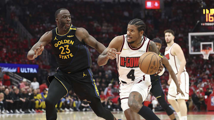 May 4, 2025; Houston, Texas, USA; Houston Rockets guard Jalen Green (4) drives with the ball as Golden State Warriors forward Draymond Green (23) defends during game seven of the first round for the 2025 NBA Playoffs at Toyota Center. Mandatory Credit: Troy Taormina-Imagn Images