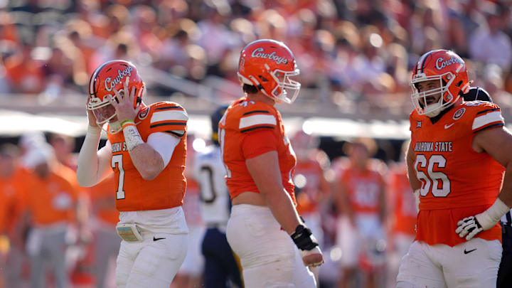 Oklahoma State Cowboys quarterback Alan Bowman (7) grabs his helmet after getting sacked during a college football game between the Oklahoma State Cowboys (OSU) and the West Virginia Mountaineers at Boone Pickens Stadium in Stillwater, Okla., Saturday, Oct. 5, 2024. Oklahoma State Cowboys quarterback Alan Bowman (7) grabs his helmet after getting sacked during a college football game between the Oklahoma State Cowboys (OSU) and the West Virginia Mountaineers at Boone Pickens Stadium in Stillwater, Okla., Saturday, Oct. 5, 2024.