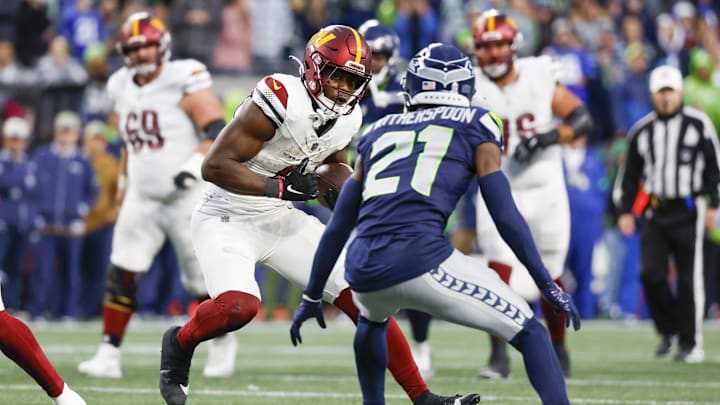Nov 12, 2023; Seattle, Washington, USA; Washington Commanders running back Brian Robinson Jr. (8) runs for yards after the catch against the Seattle Seahawks during the fourth quarter at Lumen Field. Mandatory Credit: Joe Nicholson-Imagn Images