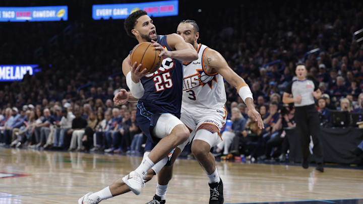 Apr 22, 2026; Oklahoma City, Oklahoma, USA; Oklahoma City Thunder guard Ajay Mitchell (25) drives to the basket past Phoenix Suns forward Dillon Brooks (3) in the second half during game two of the first round of the 2026 NBA Playoffs at Paycom Center. Mandatory Credit: Alonzo Adams-Imagn Images