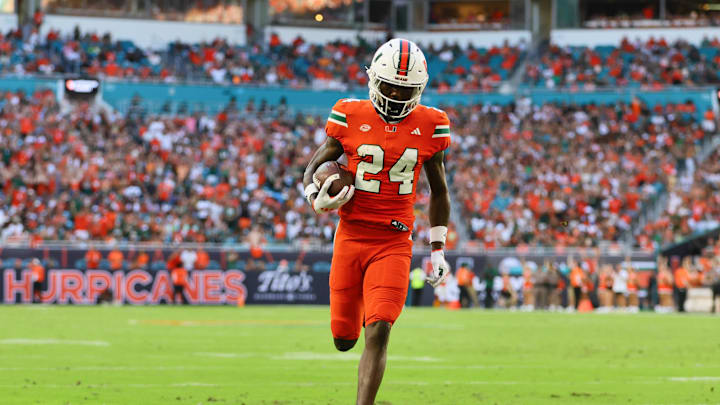 Sep 7, 2024; Miami Gardens, Florida, USA; Miami Hurricanes running back Chris Johnson Jr. (24) scores a touchdown against Florida A&M Rattlers during the second quarter at Hard Rock Stadium. Mandatory Credit: Sam Navarro-Imagn Images