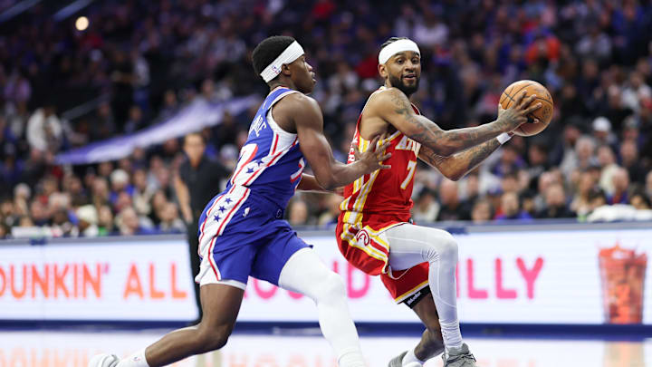 Feb 19, 2026; Philadelphia, Pennsylvania, USA; Atlanta Hawks guard Nickeil Alexander-Walker (7) drives against Philadelphia 76ers guard Vj Edgecombe (77) during the first quarter at Xfinity Mobile Arena. Mandatory Credit: Bill Streicher-Imagn Images