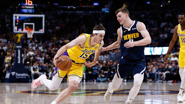 Mar 14, 2025; Denver, Colorado, USA; Los Angeles Lakers guard Austin Reaves (15) drives to the basket against Denver Nuggets guard Christian Braun (0) in the fourth quarter at Ball Arena. Mandatory Credit: Isaiah J. Downing-Imagn Images