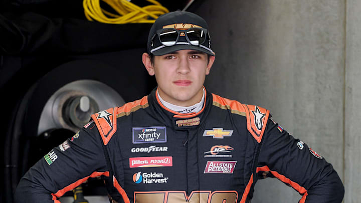NASCAR Xfinity Series driver Sammy Smith (8) stands in his garage bay Friday, July 19, 2024, during practice for the Pennzoil 250 at Indianapolis Motor Speedway.