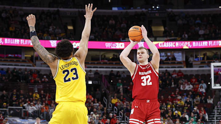 Mar 14, 2026; Chicago, IL, USA; Wisconsin Badgers forward Aleksas Bieliauskas (32) shoots against Michigan Wolverines forward Yaxel Lendeborg (23) during the first half at United Center. Mandatory Credit: Kamil Krzaczynski-Imagn Images Mar 14, 2026; Chicago, IL, USA; Wisconsin Badgers forward Aleksas Bieliauskas (32) shoots against Michigan Wolverines forward Yaxel Lendeborg (23) during the first half at United Center. Mandatory Credit: Kamil Krzaczynski-Imagn Images