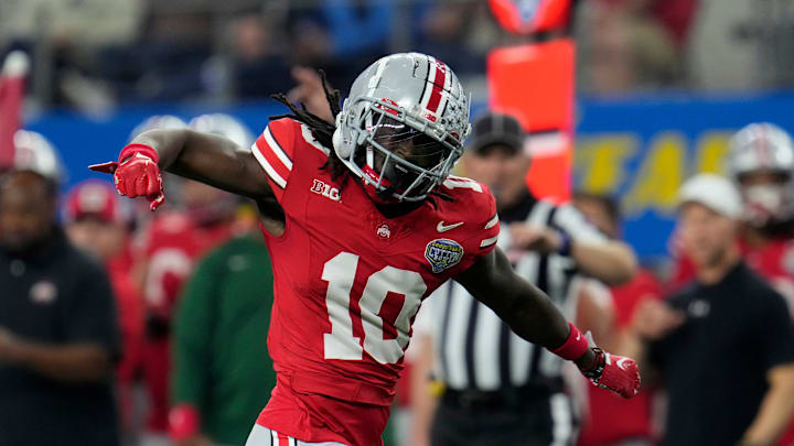 Dec 29, 2023; Arlington, Texas, USA; Ohio State Buckeyes cornerback Denzel Burke (10) celebrates a