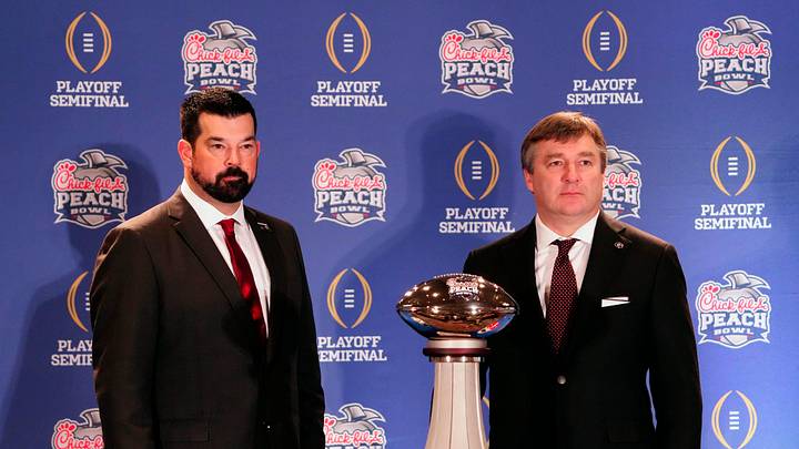 Dec 30, 2022; Atlanta, GA, USA; Ohio State Buckeyes head coach Ryan Day and Georgia Bulldogs head coach Kirby Smart pose for a photo during the coaches Peach Bowl press conference at the Westin Peachtree Plaza.