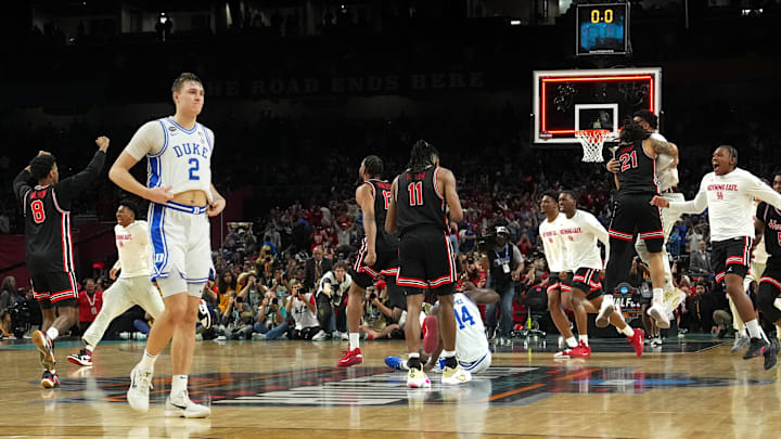 Apr 5, 2025; San Antonio, TX, USA; Duke Blue Devils forward Cooper Flagg (2) walks off the court as Houston Cougars players celebrate after Houston’s semifinal win in the men's 2025 NCAA tournament at Alamodome. Mandatory Credit: Bob Donnan-Imagn Images