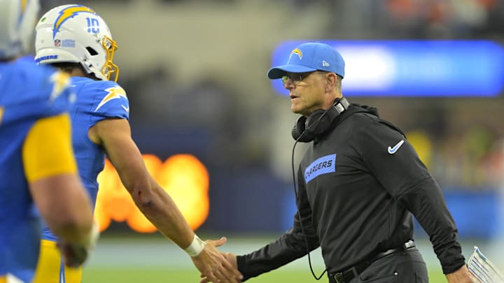 Dec 19, 2024; Inglewood, California, USA;  Los Angeles Chargers head coach Jim Harbaugh congratulates quarterback Justin Herbert (10) after a touchdown in the second half against the Denver Broncos at SoFi Stadium. Mandatory Credit: Jayne Kamin-Oncea-Imagn Images