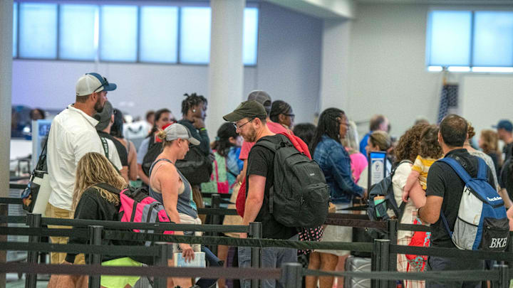 Passengers at Pensacola International Airport go through security checks Sunday, July 2, 2023.