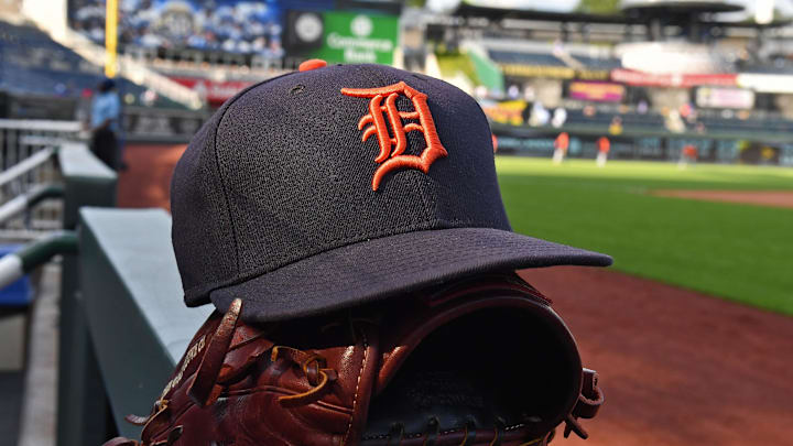 A general view of a Detroit Tigers cap and glove on the dugout at Kauffman Stadium in Kansas City.