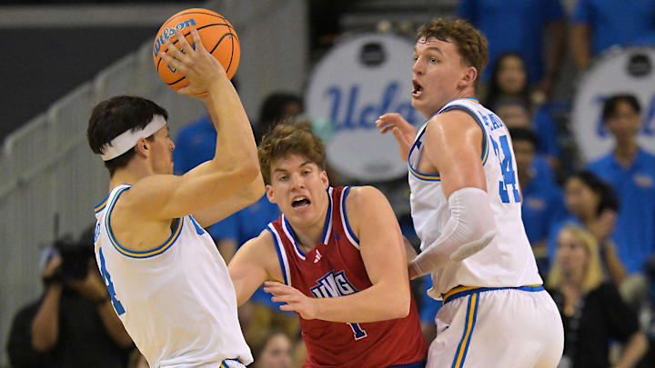 Nov 10, 2025; Los Angeles, California, USA;  UCLA Bruins forward Tyler Bilodeau (34) looks for a pass from UCLA Bruins guard Jamar Brown (4) as West Georgia Wolves guard Brady Hardewig (1) defends during the first half at Pauley Pavilion presented by Wescom Financial. Mandatory Credit: Jayne Kamin-Oncea-Imagn Images